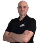 Jim Mucci, a mortgage loan originator, standing confidently with arms crossed in a Treeside Financial shirt.